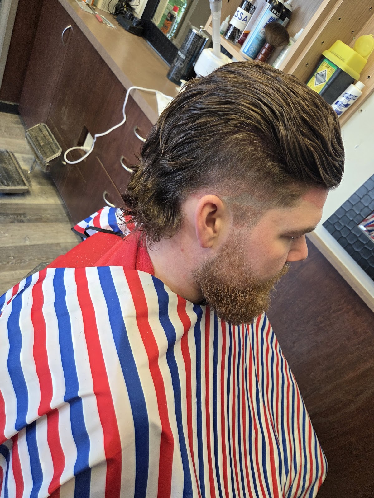 Fresh men's haircut with textured styling at Mike's Barber Shop