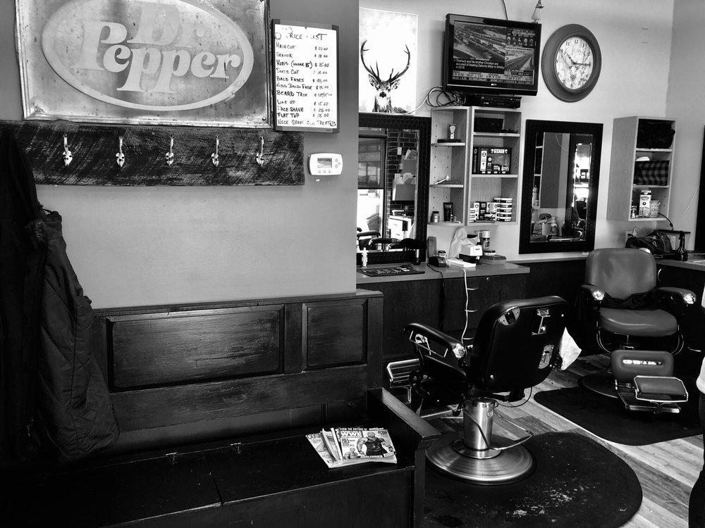 Classic black-and-white view of Mike's Barber Shop interior with vintage decor