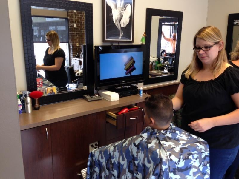 Barber giving a haircut at Mike's Barber Shop