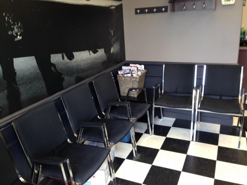Classic waiting area with checkered floor and vintage decor at Mike's Barber Shop